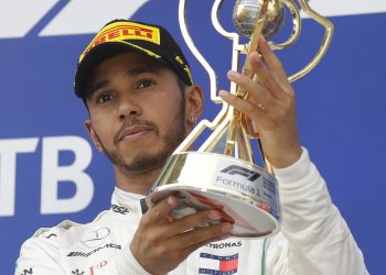 Mercedes driver Lewis Hamilton celebrates with the trophy after winning the Russian Grand Prix at the Sochi Autodrom circuit in Sochi