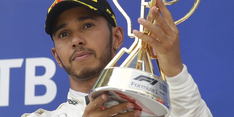 Mercedes driver Lewis Hamilton celebrates with the trophy after winning the Russian Grand Prix at the Sochi Autodrom circuit in Sochi