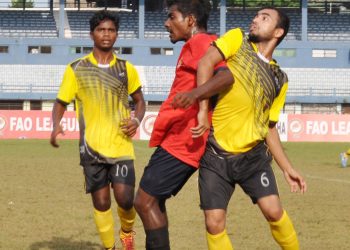 Rising Student Club and Radha Raman Club players tussle for the ball during their match at Barabati Stadium, Monday