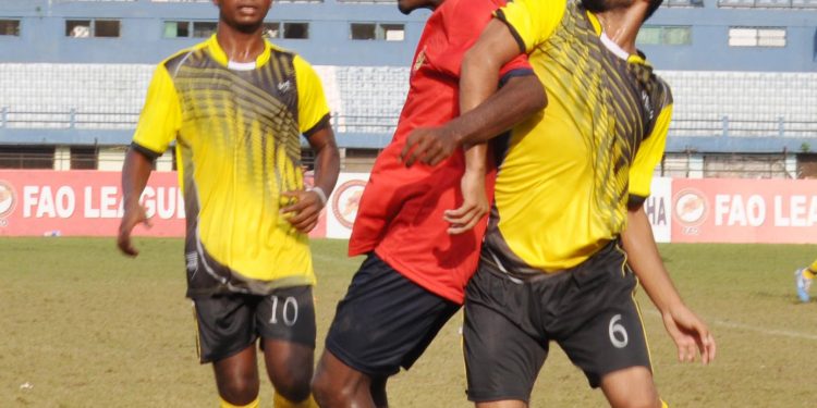 Rising Student Club and Radha Raman Club players tussle for the ball during their match at Barabati Stadium, Monday