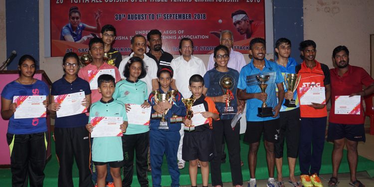 Winners in different categories of the YGTTA All Odisha Open Table Tennis Championships pose with their trophies and certificates along with guests at Cuttack, Saturday   