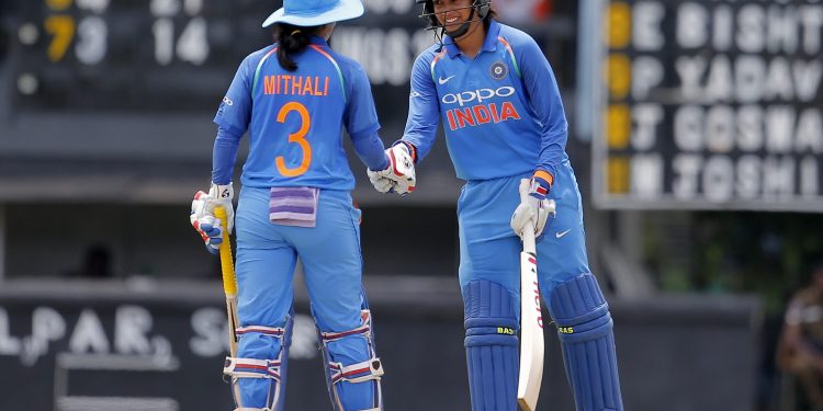 Mithali Raj (L) congratulates Smriti Mandhana for scoring a half century against Sri Lanka during their 3rd ODI