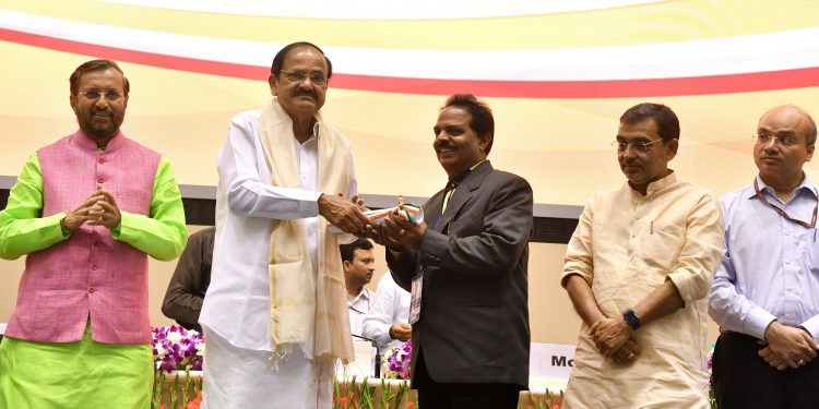 Om Prakash Mishra receives the award from the Vice-President in New Delhi.