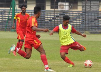 Radhagobinda Club and Rising Star Club players tussle for the ball during their match at Barabati Stadium in Cuttack Friday