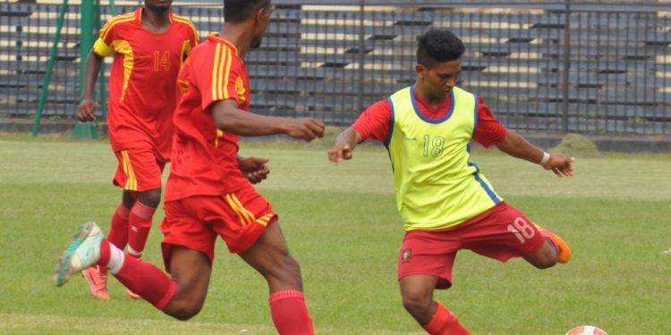 Radhagobinda Club and Rising Star Club players tussle for the ball during their match at Barabati Stadium in Cuttack Friday