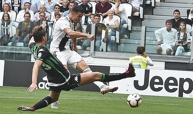 Cristiano Ronaldo of Juventus shoots to score his second goal in the Serie A game against Sassuolo, Sunday