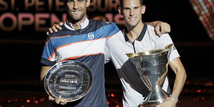 Dominic Thiem (R) and Martin Klizan pose with their trophies in St. Petersburg, Sunday   