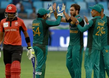 Usman Khan (C) celebrates with teammates after dismissing a Hong Kong batsman in Dubai