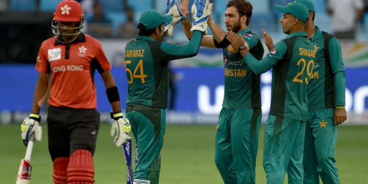 Usman Khan (C) celebrates with teammates after dismissing a Hong Kong batsman in Dubai