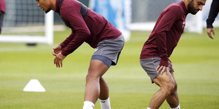 Liverpool’s Mo Salah (R) trains with a teammate, ahead of their Champions League clash against PSG