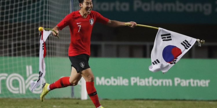 Son Heung Min of South Korea celebrates after winning the gold medal match against Japan at Asian Games