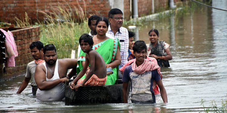 Officials visit Sujata Nagar on a boat, Tuesday OP photo