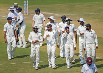 Indian players celebrate their victory over West Indies in their first Test match, in Rajkot