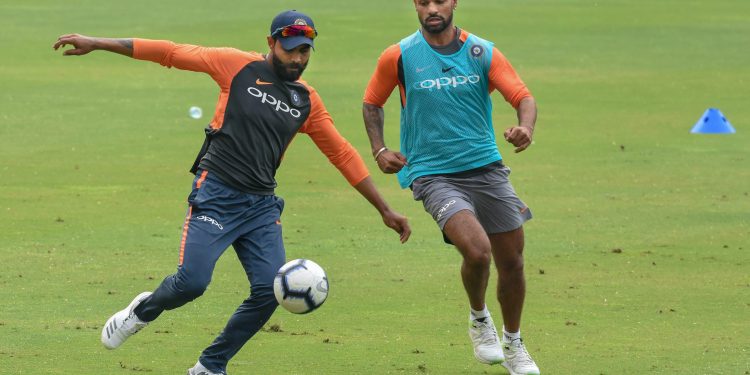 Indian cricketers Shikhar Dhawan and  Ravindra Jadeja play football during a practice session ahead of the first ODI against West Indies
