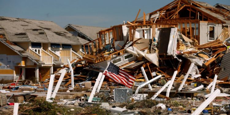 An American flag flies amongst rubble left in the aftermath of Hurricane Michael in Mexico Beach.