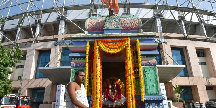 Priest Hamumanth Sharma stands outside the temple at Hyderabad cricket ground before the start of first day's play of second test match between India and West Indies, Friday