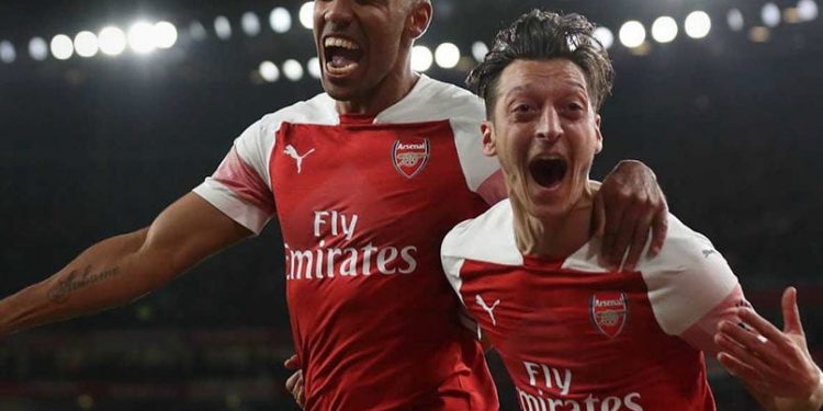 Pierre-Emerick Aubameyang (L) and Mesut Ozil celebrate Arsenal’s first goal against Leicester City, Monday 