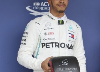 Lewis Hamilton of Mercedes poses with the pole position award in Suzuka, Saturday   