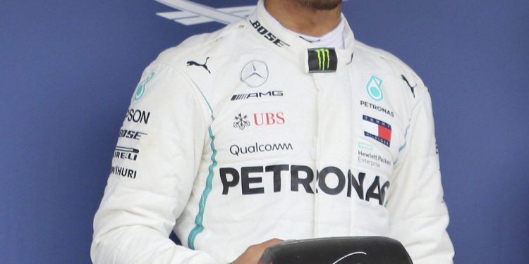 Lewis Hamilton of Mercedes poses with the pole position award in Suzuka, Saturday   