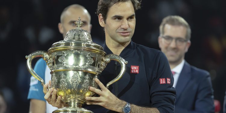 Roger Federer holds the trophy during the victory ceremony At Basel