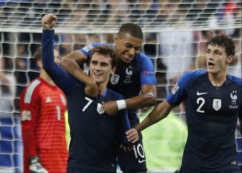 Antoine Griezmann (7), with Kylian Mbappe, clenches his fist after scoring his second goal against Germany in Paris, Tuesday 