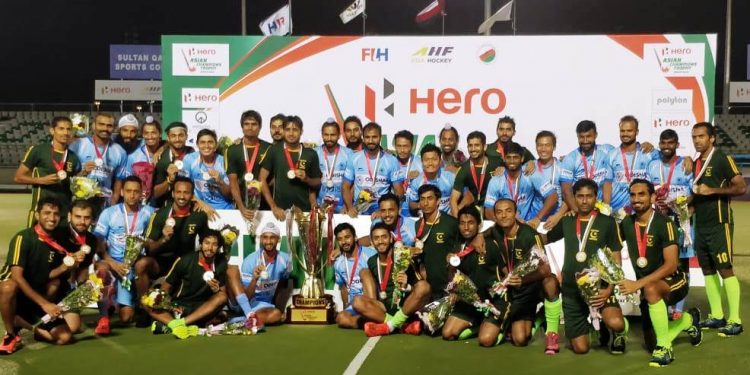 India and Pakistan players pose with the joint winners’ trophy and medals in Muscat, Sunday     