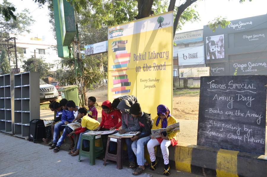 Kids reading books at the special reading session organised by Bakul Foundation