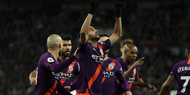 Manchester City’s Riyad Mahrez (C) points towards the sky in the memory of his late boss after scoring against Spurs, Monday