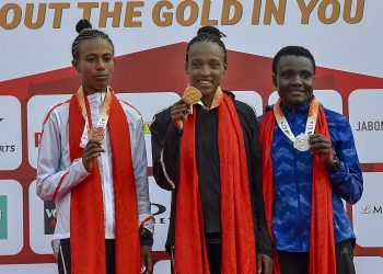 Tsehay Gemechu (C), Joyciline Jepkosgei (R) and Zeineba Yimer pose for photos during the medal ceremony at Jawaharlal Nehru Stadium in New Delhi, Sunday