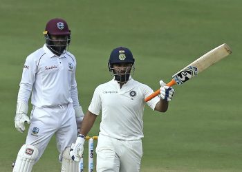 Rishabh Pant raises his bat after completing his half century against West Indies in Hyderabad, Saturday   