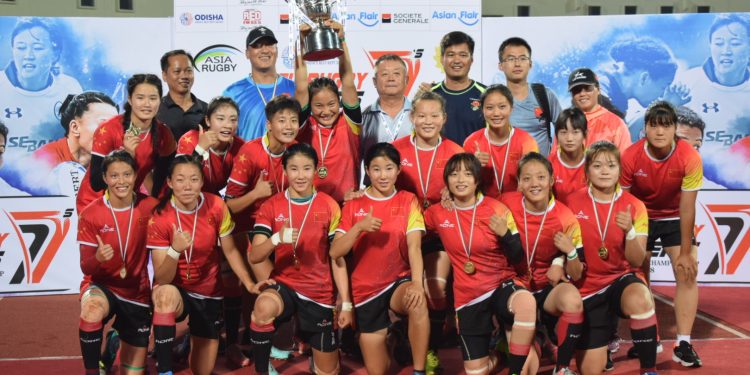 Triumphant Chinese players along with the officials celebrate with the winner’s trophy at Kalinga Stadium, Sunday