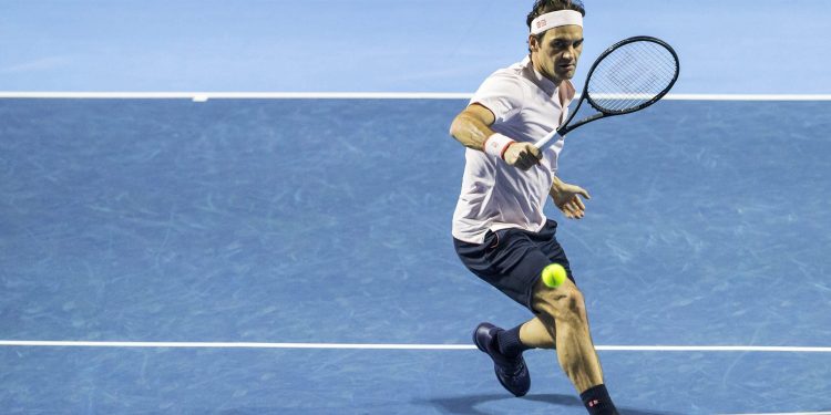 Roger Federer returns a ball to Daniil Medvedev during their semifinal match at the Swiss Indoors tennis tournament