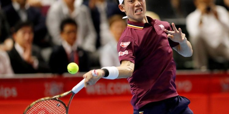 Kei Nishikori plays a shot against Richard Gasquet in Tokyo, Saturday