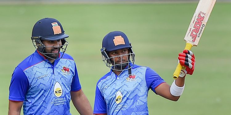 Mumbai’s Prithvi Shaw (R) raises his bat after completing half century as Rohit Sharma looks on during their match against Hyderabad in Bangalore, Wednesday 