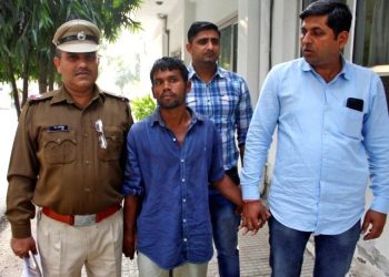 Police escort a man, accused of raping and killing a three-year-old girl, outside a police station in Gurugram on the outskirts of New Delhi, November 20, 2018. REUTERS/Stringer