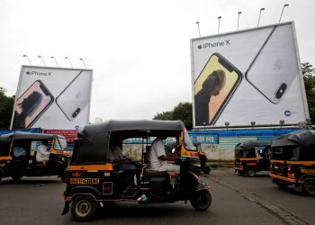 FILE PHOTO: Auto-rickshaws drive past the hoardings of Apple iPhone X mobile phones in Mumbai, India July 27, 2018. REUTERS/Francis Mascarenhas/File Photo
