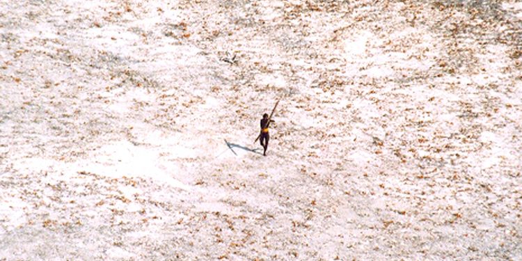 FILE PHOTO: A Sentinel tribal man aims with his bow and arrow at an Indian Coast Guard helicopter as it flies over the island for a survey of the damage caused by the tsunami in India's Andaman and Nicobar archipelago, December 28, 2004. REUTERS/Indian Coast Guard/Handout