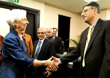 Finance Minister Asad Umar and IMF chief Christine Lagarde shake hands before their meeting.