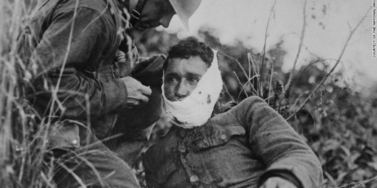 A US soldier treats a comrade's wound in France in 1918. World War I changed the US in ways that linger