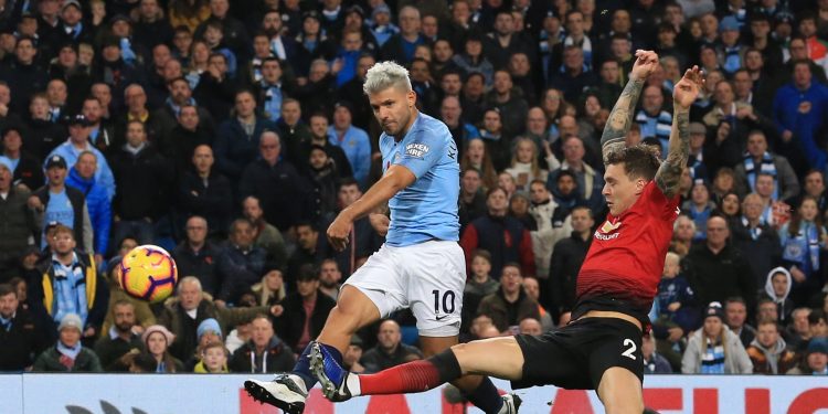 Sergio Aguero (10) strikes the ball past a sliding Man United defender straight into the opposition net (not in picture) at Etihad Stadium, Sunday