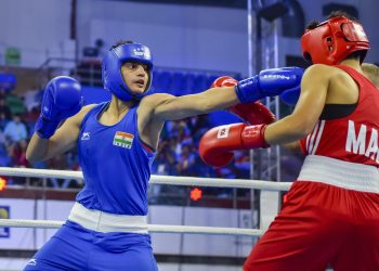 Sonia (in blue) lands punch on his Moroccan opponent Toujani Doaa (in red) during their bout at women’s World Championships in New Delhi, Saturday           