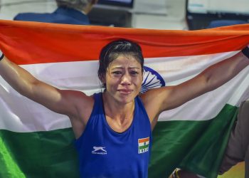 Mary Kom poses with Tricolour as she celebrates after winning the women’s light flyweight 45-48 kg final of AIBA Womens World Boxing Championships, in New Delhi, Saturday  