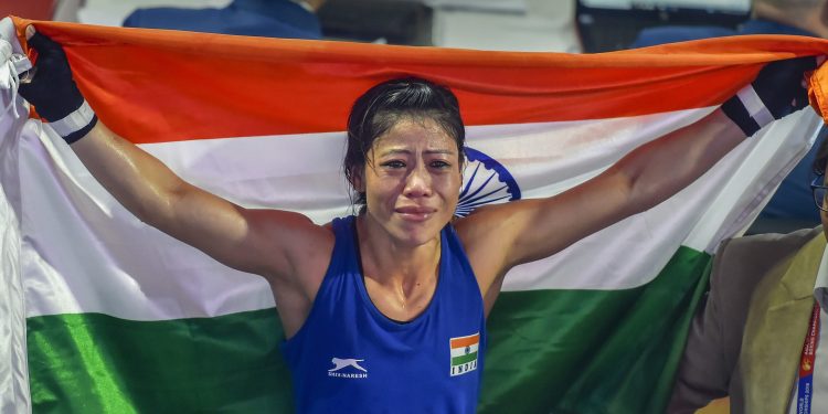 Mary Kom poses with Tricolour as she celebrates after winning the women’s light flyweight 45-48 kg final of AIBA Womens World Boxing Championships, in New Delhi, Saturday  