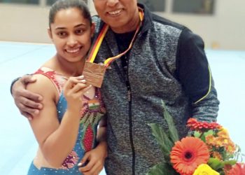 Indian gymnast Dipa Karmakar poses with her coach Bisweswar Nandi after wining bronze in Vault event at Artistic Gymnastic World Cup in Cottbus, Germany, Saturday