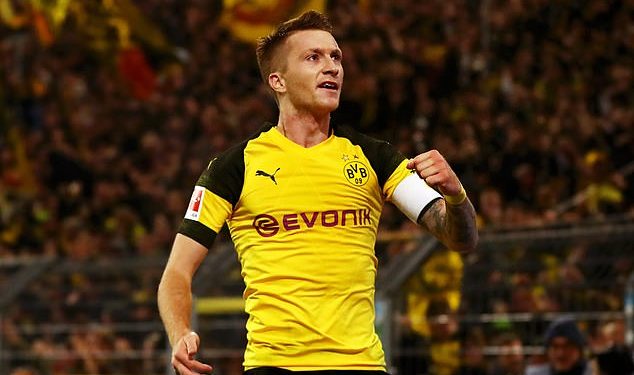 Marco Reus wheels away in celebration after scoring against Bayern Munich in Dortmund, Saturday