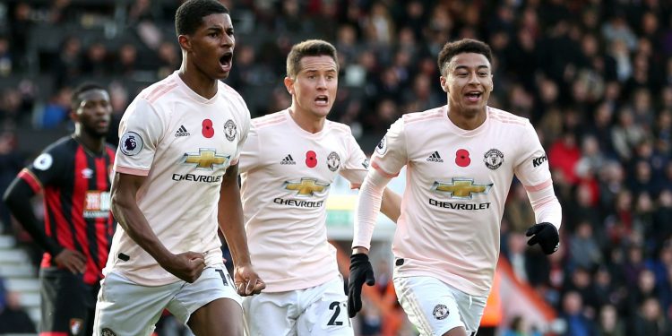 Marcus Rashford (L) celebrates with Ander Herrera (C) and Jesse Lingard after scoring the late winner against Bournemouth, Saturday