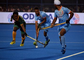 India’s Lalit Upadhyay (C) dribbles pasta South African player as another Indian player looks on during their match at the Kalinga Stadium, Wednesday