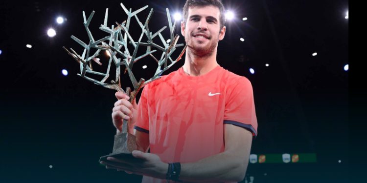 Karen Khachanov poses with the winner’s trophy after defeating Novak Djokovic in the final in Paris, Sunday