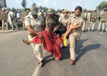 A protesting farmer being taken into custody