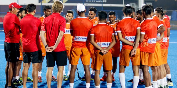 Indian players attend a team meeting after their practice at the Kalinga Stadium in Bhubaneswar